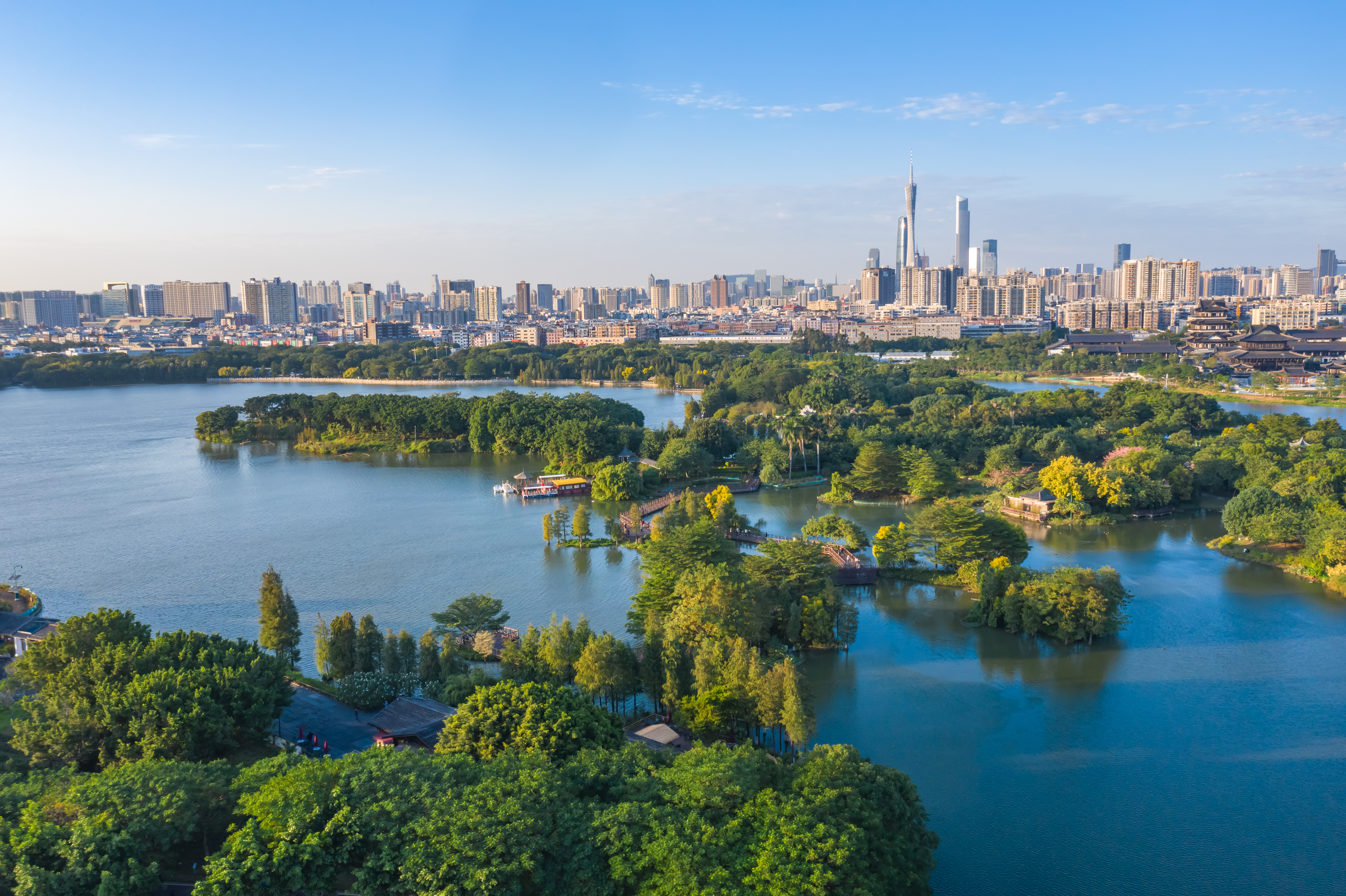 Guangzhou demonstrates community engagement and ecological sustainability alongside continued urban development.