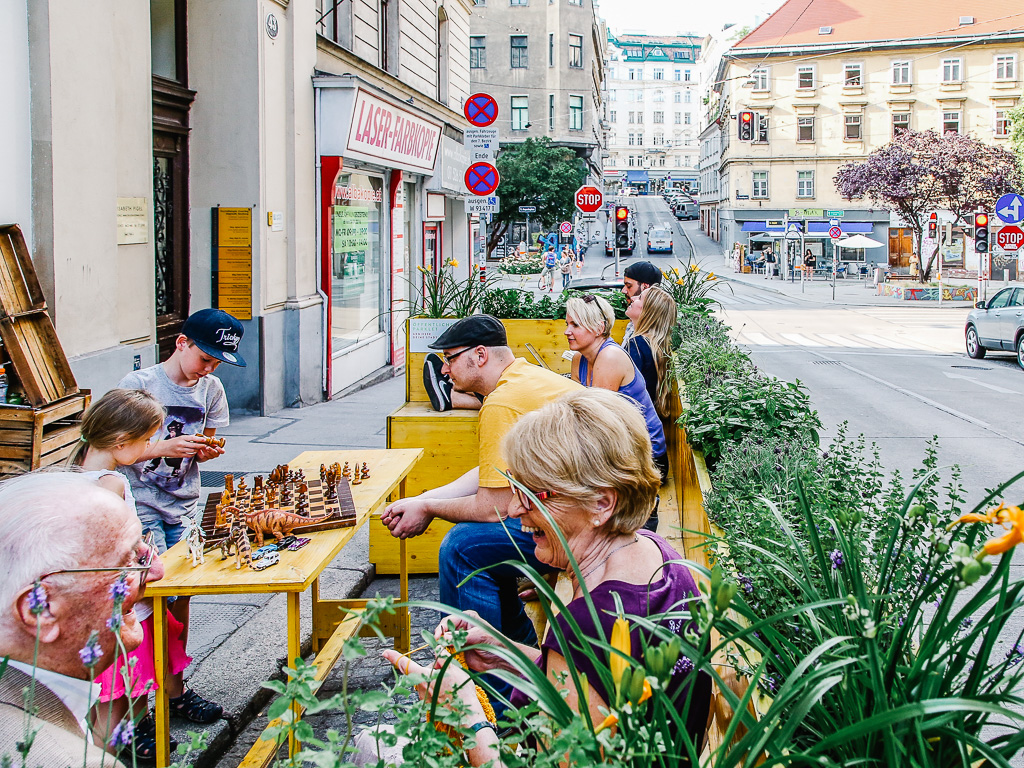 Residents playing chess at a parklet